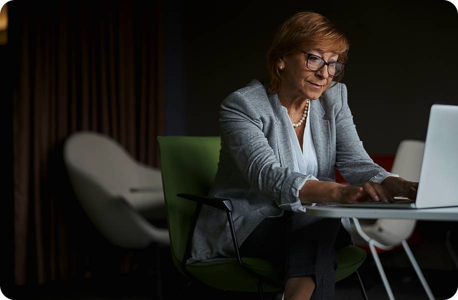 Senior office worker using her laptop